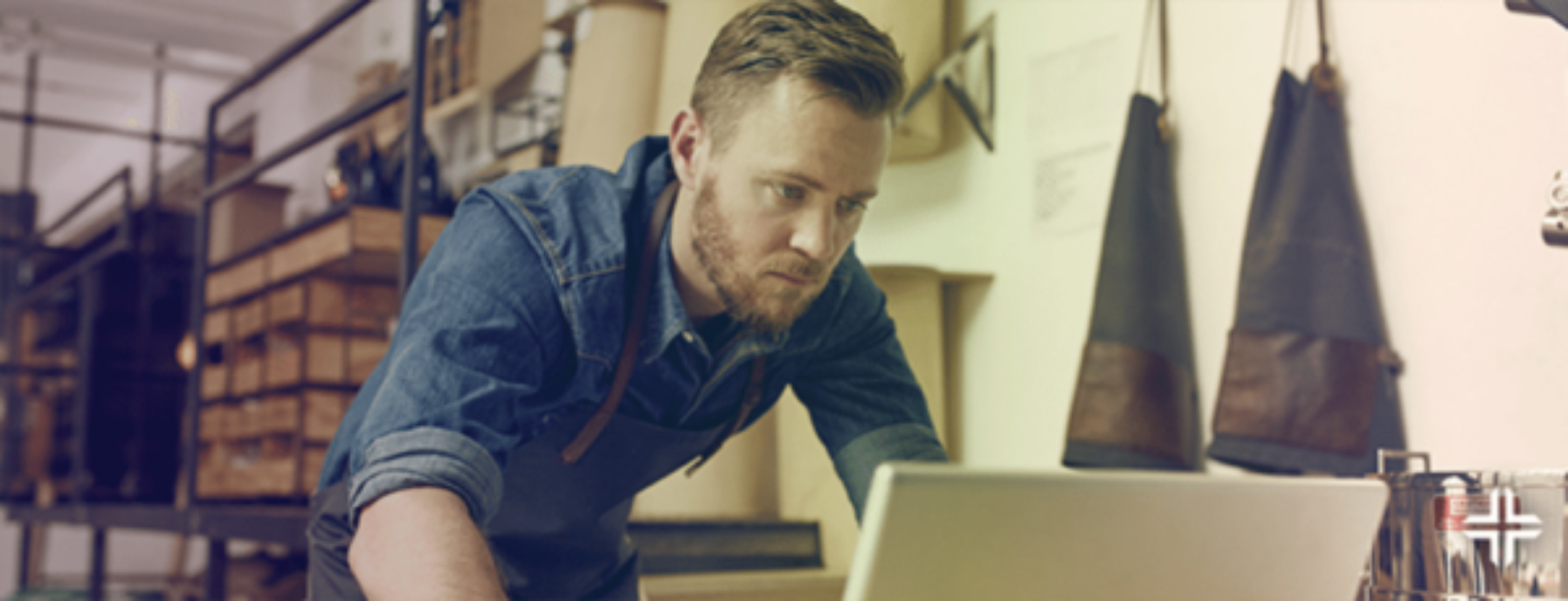 Man working at a store using a computer