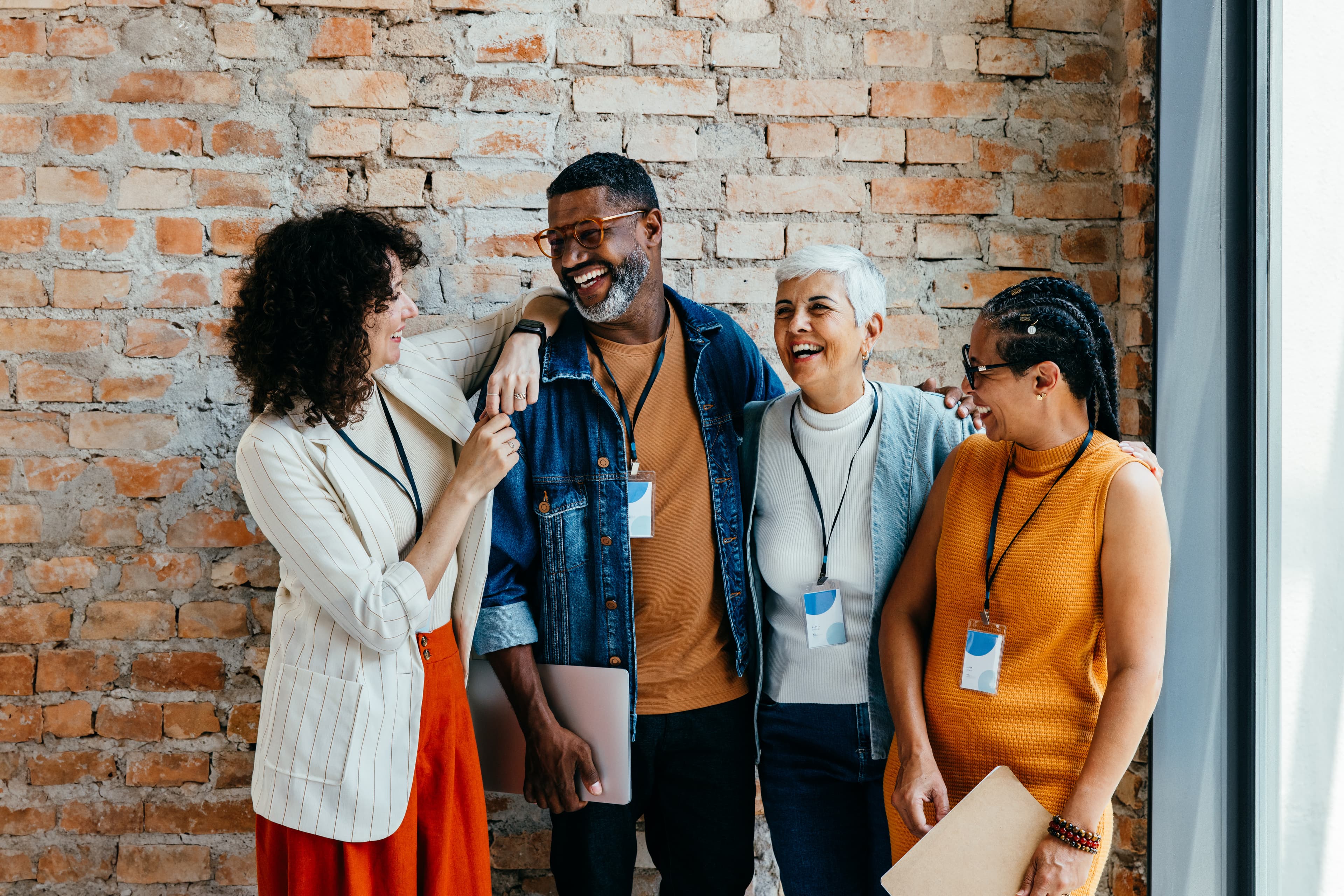 Diverse coworkers enjoy a lighthearted moment, showcasing teamwork and friendship in a modern office environment. Ideal for concepts of collaboration and diversity.