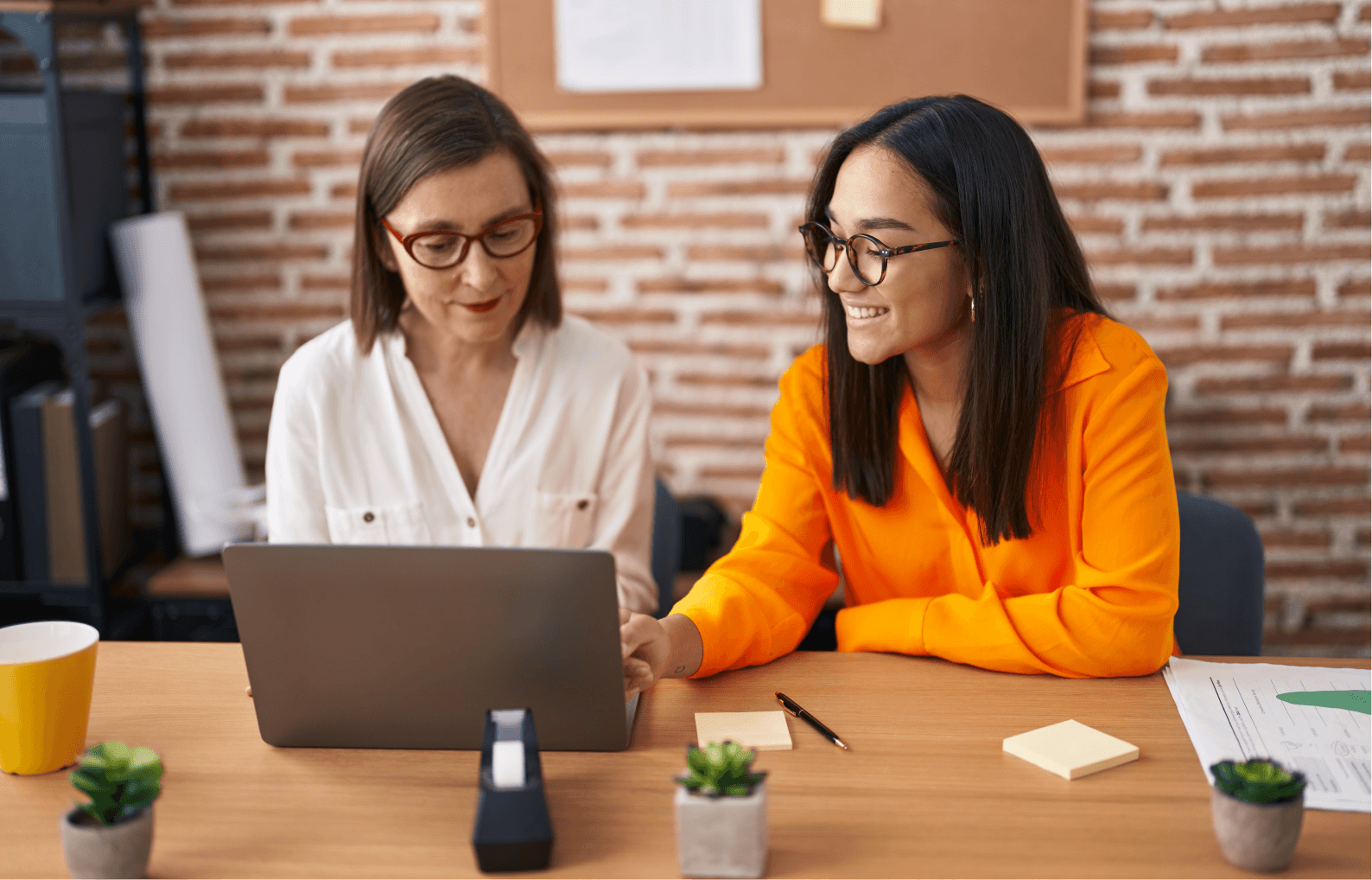 2 women at a desk speaking