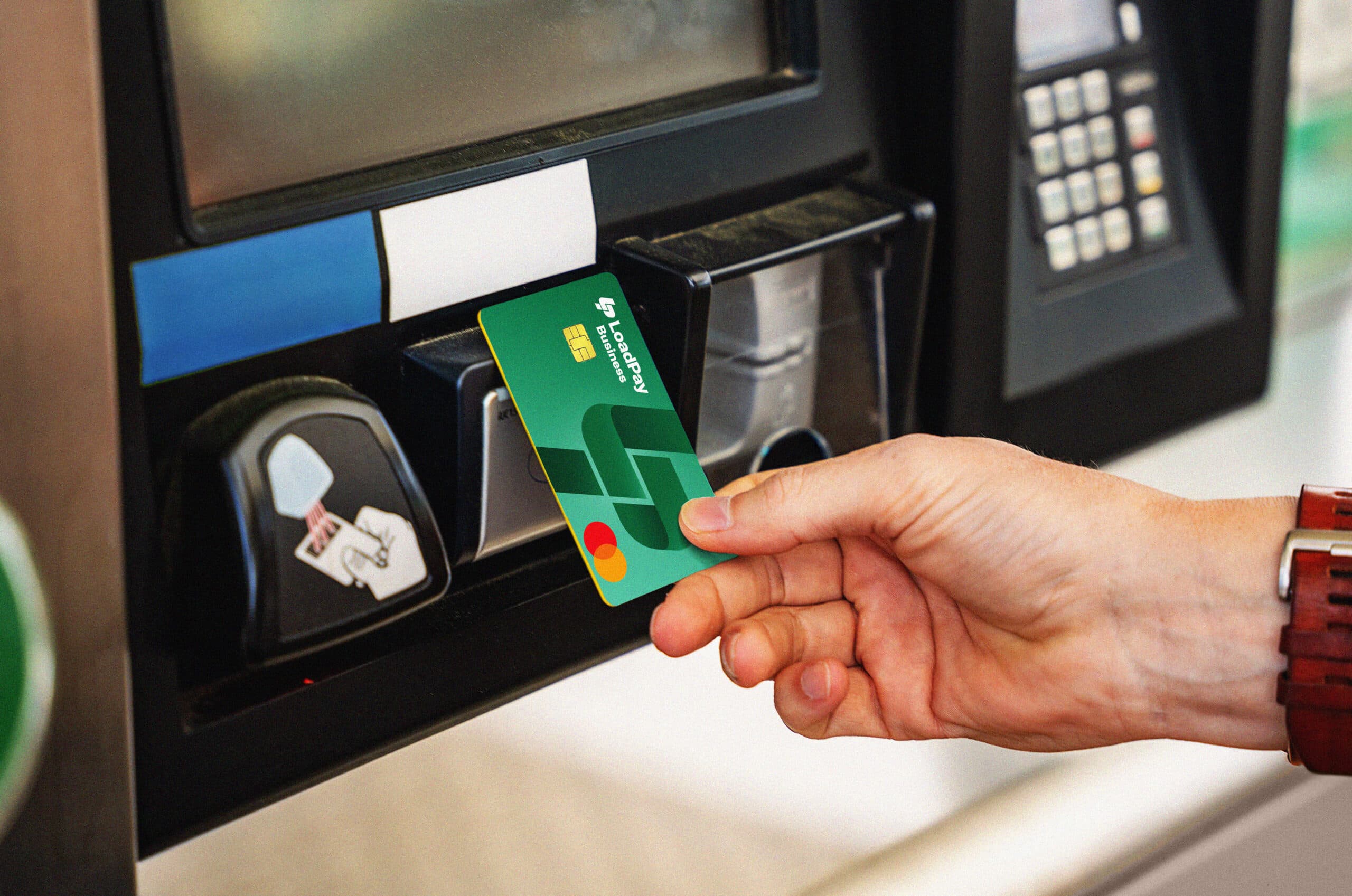 Man using the LoadPay debit card to pay for fuel